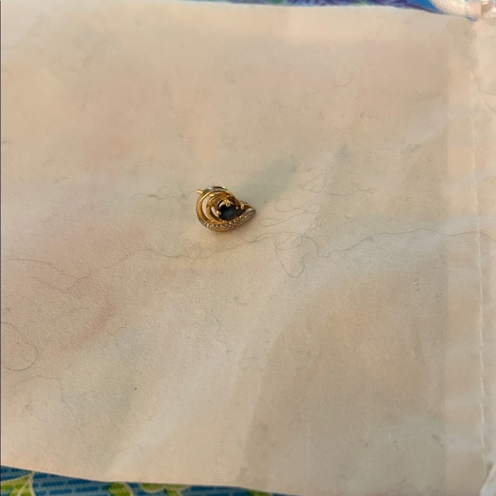 14K gold earring With a Sapphire. And Several Small Diamonds.